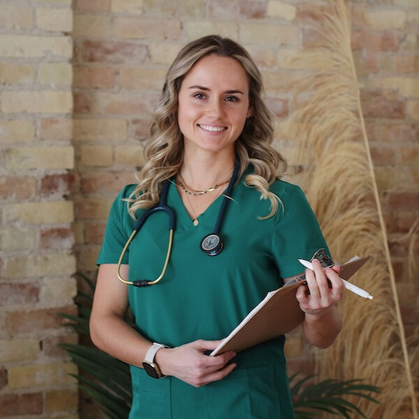 Dr. Mariah smiling in a clinical setting
